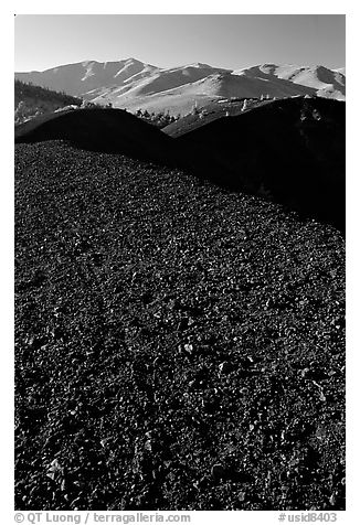 Dark pumice, cinder cones, and Pioneer Mountains. Craters of the Moon National Monument and Preserve, Idaho, USA (black and white)
