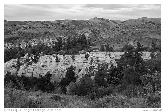 Sandstone pinnacles and hill with last light. Upper Missouri River Breaks National Monument, Montana, USA (black and white)