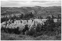 Sandstone pinnacles and hill with last light. Upper Missouri River Breaks National Monument, Montana, USA ( black and white)