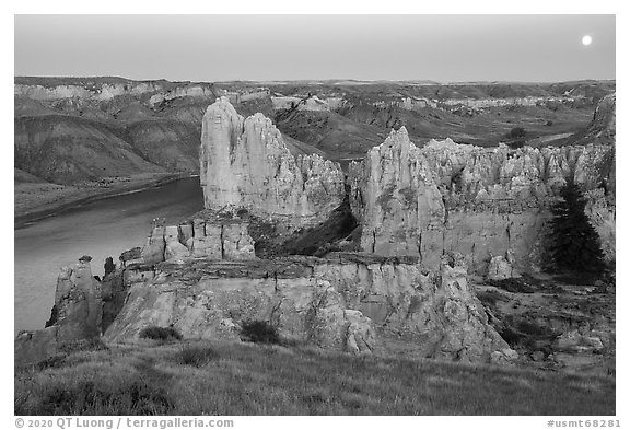 Sandstone spires and moon at twilight. Upper Missouri River Breaks National Monument, Montana, USA (black and white)