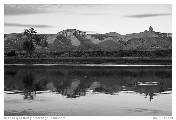 Riverbank with cliff and spires at sunset. Upper Missouri River Breaks National Monument, Montana, USA (black and white)