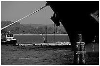 Timber, tugboat, and cargo boat bow. Oregon, USA (black and white)