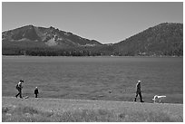 Family strolling on shore of East Lake. Newberry Volcanic National Monument, Oregon, USA (black and white)