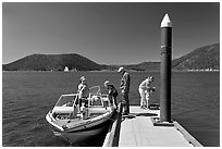 Family boarding boat, East Lake. Newberry Volcanic National Monument, Oregon, USA ( black and white)