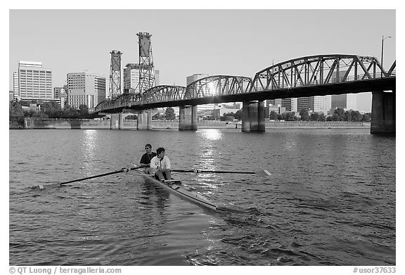 Men on double-oar shell rowing on Williamette River. Portland, Oregon, USA (black and white)