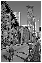 Jogger and cyclist on Hawthorne Bridge. Portland, Oregon, USA (black and white)