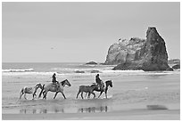 Women ridding horses on beach. Bandon, Oregon, USA (black and white)