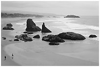 Beach at Face Rock with two people walking. Bandon, Oregon, USA ( black and white)