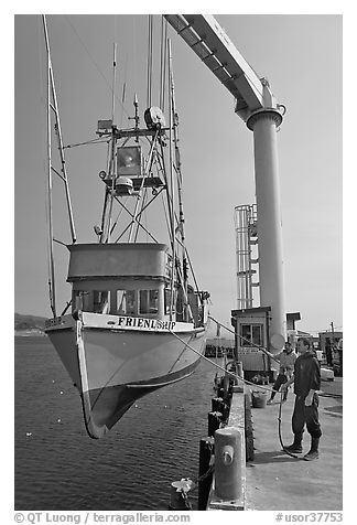 Fishing boat hoisted from water, Port Orford. Oregon, USA