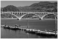 Small boat deck and Rogue River bridge. Oregon, USA (black and white)