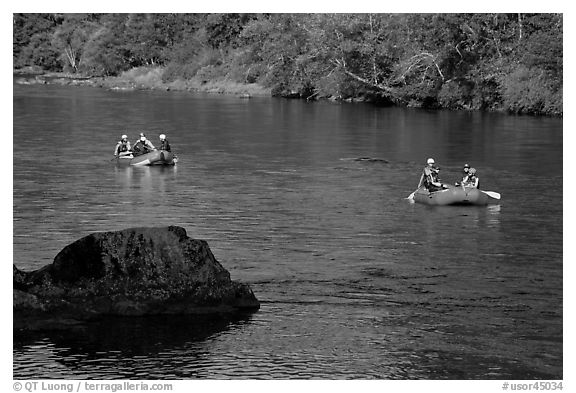Two Rafts passing boulder, McKenzie river. Oregon, USA