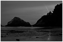 Heceta Head and lighthouse beam from beach by night. Oregon, USA (black and white)