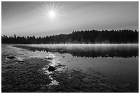 Sun and fog rising of Hyatt Lake. Cascade Siskiyou National Monument, Oregon, USA ( black and white)