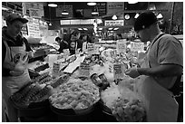 Countermen unloading seafood,  Pike Place Market. Seattle, Washington ( black and white)