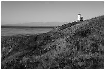 Grassy hill with lighthouse, Cattle Point Natural Resources Conservation Area, San Juan Islands National Monument. Washington ( black and white)