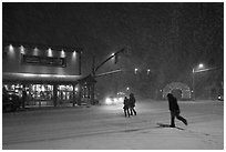People cross street in night blizzard. Jackson, Wyoming, USA (black and white)
