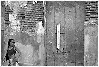 Woman in front of a decaying brick wall, Ponce. Puerto Rico (black and white)