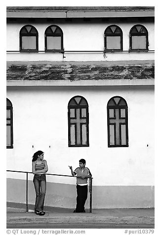 Woman and boy talking besides a church, La Parguera. Puerto Rico