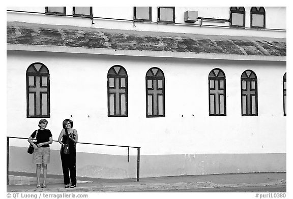 Two women standing in front of a church, La Parguera. Puerto Rico