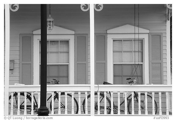 Bicycle on pastel-colored porch. Key West, Florida, USA (black and white)