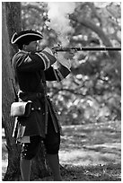 Man in period costume fires smooth bore musket, Fort Matanzas National Monument. St Augustine, Florida, USA ( black and white)