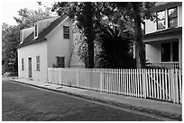 White picket fence and houses on cobblestone street. St Augustine, Florida, USA ( black and white)