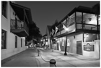 Old street and historic buildings with flags by night. St Augustine, Florida, USA ( black and white)