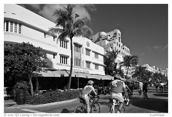Cyclists passing Art Deco hotels, Miami Beach. Florida, USA (black and white)
