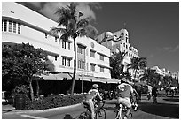 Cyclists passing Art Deco hotels, Miami Beach. Florida, USA ( black and white)