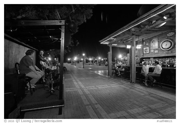Salsa musicians and bar at night, Mallory Square. Key West, Florida, USA (black and white)