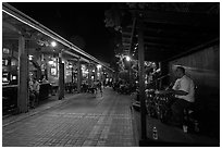 Musicians and restaurant at night, Mallory Square. Key West, Florida, USA (black and white)