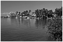 Conch cottages lining edge of Florida Bay, Conch Key. The Keys, Florida, USA ( black and white)