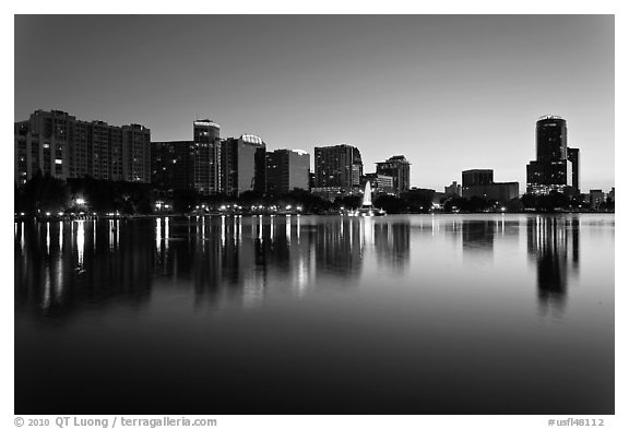 Orlando skyline at sunset reflected in lake Eola. Orlando, Florida, USA (black and white)
