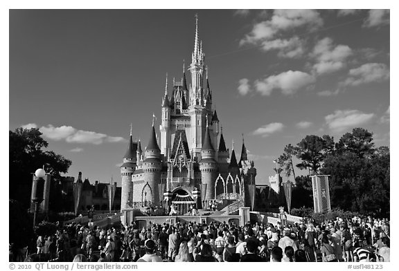 Iconic Cindarella Castle with tourists gathered for show, Magic Kingdom. Orlando, Florida, USA (black and white)