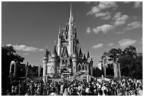 Iconic Cindarella Castle with tourists gathered for show, Magic Kingdom. Orlando, Florida, USA (black and white)