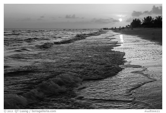 Beach with people in the distance at sunset, Sanibel Island. Florida, USA (black and white)