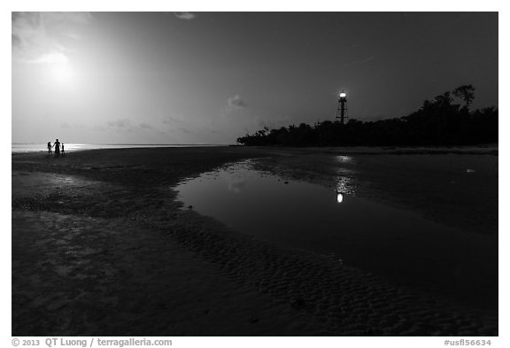 Lighthouse beach with family in distance and moonlight, Sanibel Island. Florida, USA (black and white)