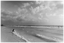 Woman sitting in water, Fort De Soto beach. Florida, USA ( black and white)
