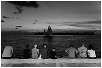Tourists watching ocean after sunset, Mallory Square. Key West, Florida, USA (black and white)