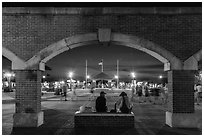 Mallory Square at dust seen through arches. Key West, Florida, USA ( black and white)