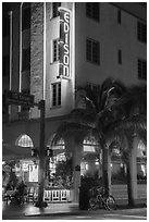Corner street with Edison hotel, bicycle and palm tree at night, Miami Beach. Florida, USA ( black and white)