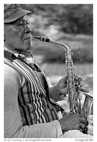 African-American musician with saxophone in square. Savannah, Georgia, USA (black and white)