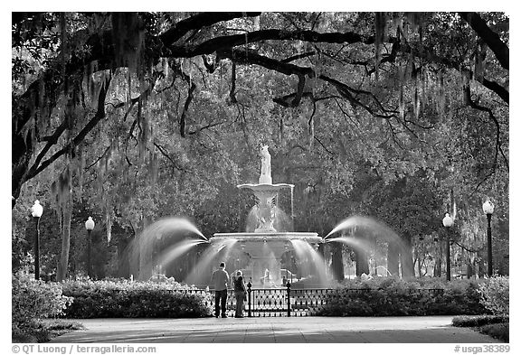 Fountain in Forsyth Park with couple standing. Savannah, Georgia, USA