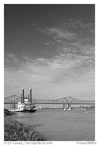 Mississippi River, paddle riverboat, and bridge. Natchez, Mississippi, USA (black and white)