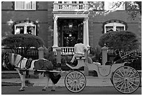 Horse carriage in front of historic mansion. Charleston, South Carolina, USA ( black and white)