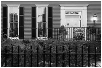 House facade at dusk with roses in front yard. Charleston, South Carolina, USA ( black and white)