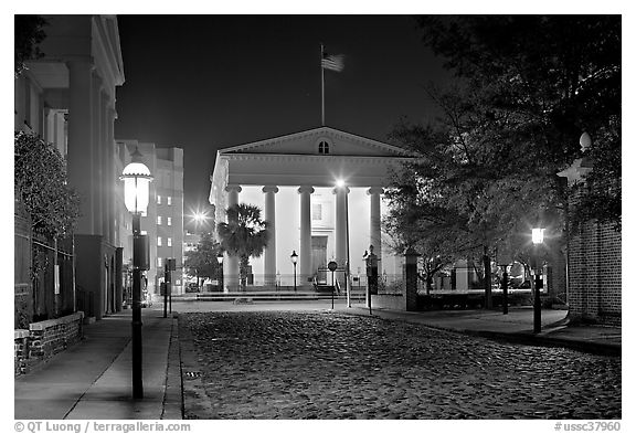 Street with cobblestone pavement at night. Charleston, South Carolina, USA