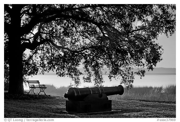 Cannon, and bench overlooking Beaufort Bay at sunrise. Beaufort, South Carolina, USA (black and white)