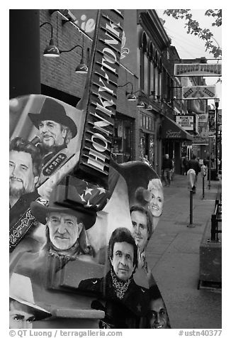 Guitar-shaped sign with images of famous singers on Broadway sidewalk. Nashville, Tennessee, USA (black and white)