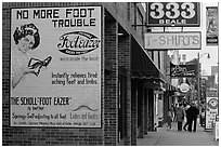 Old advertising on brick building and sidewalk, Beale street. Memphis, Tennessee, USA ( black and white)